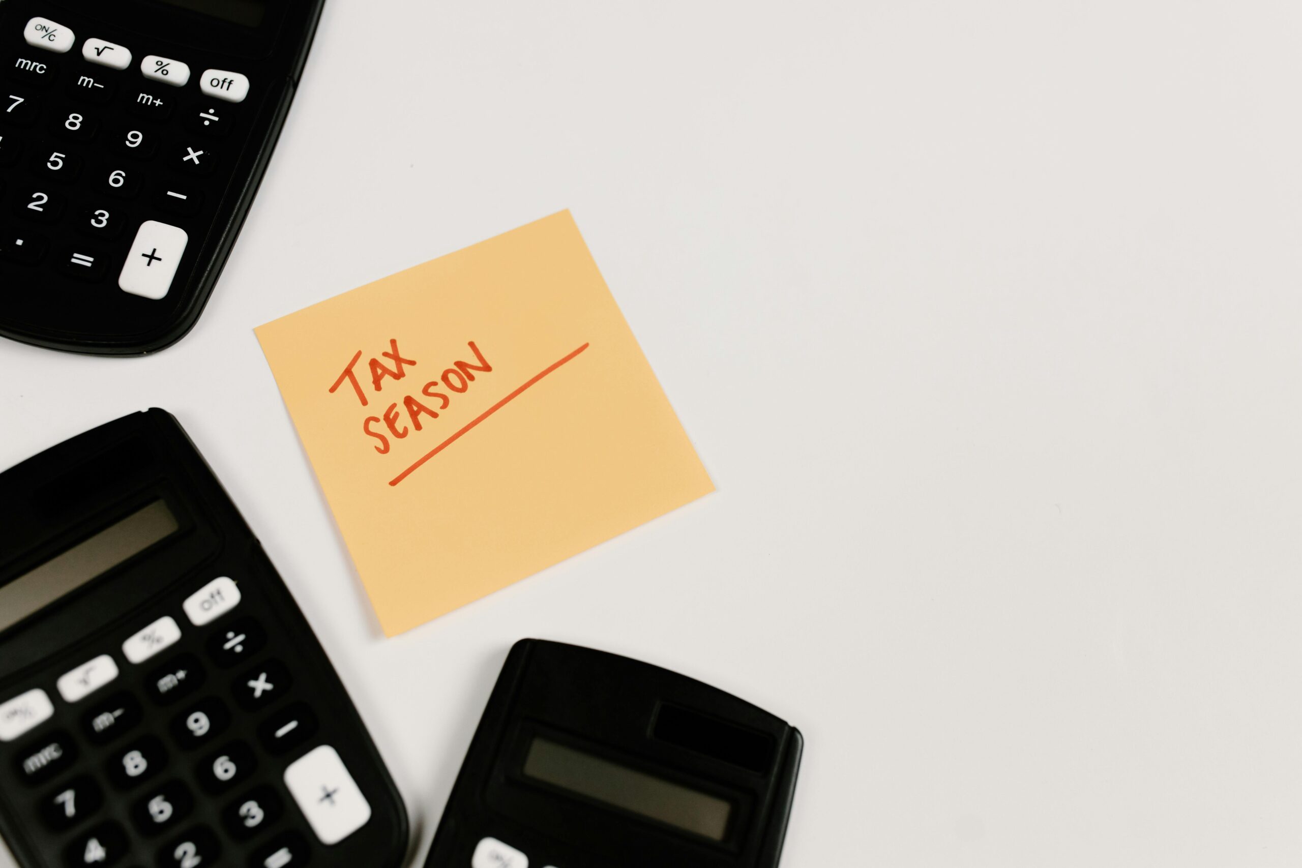 Calculator and tax season sticky note.