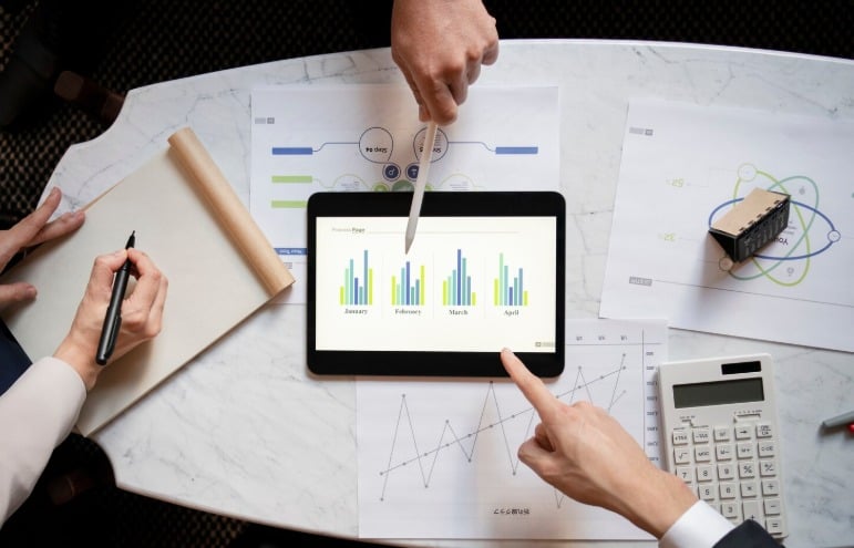 Tablet showing sales graphs and business analysis.