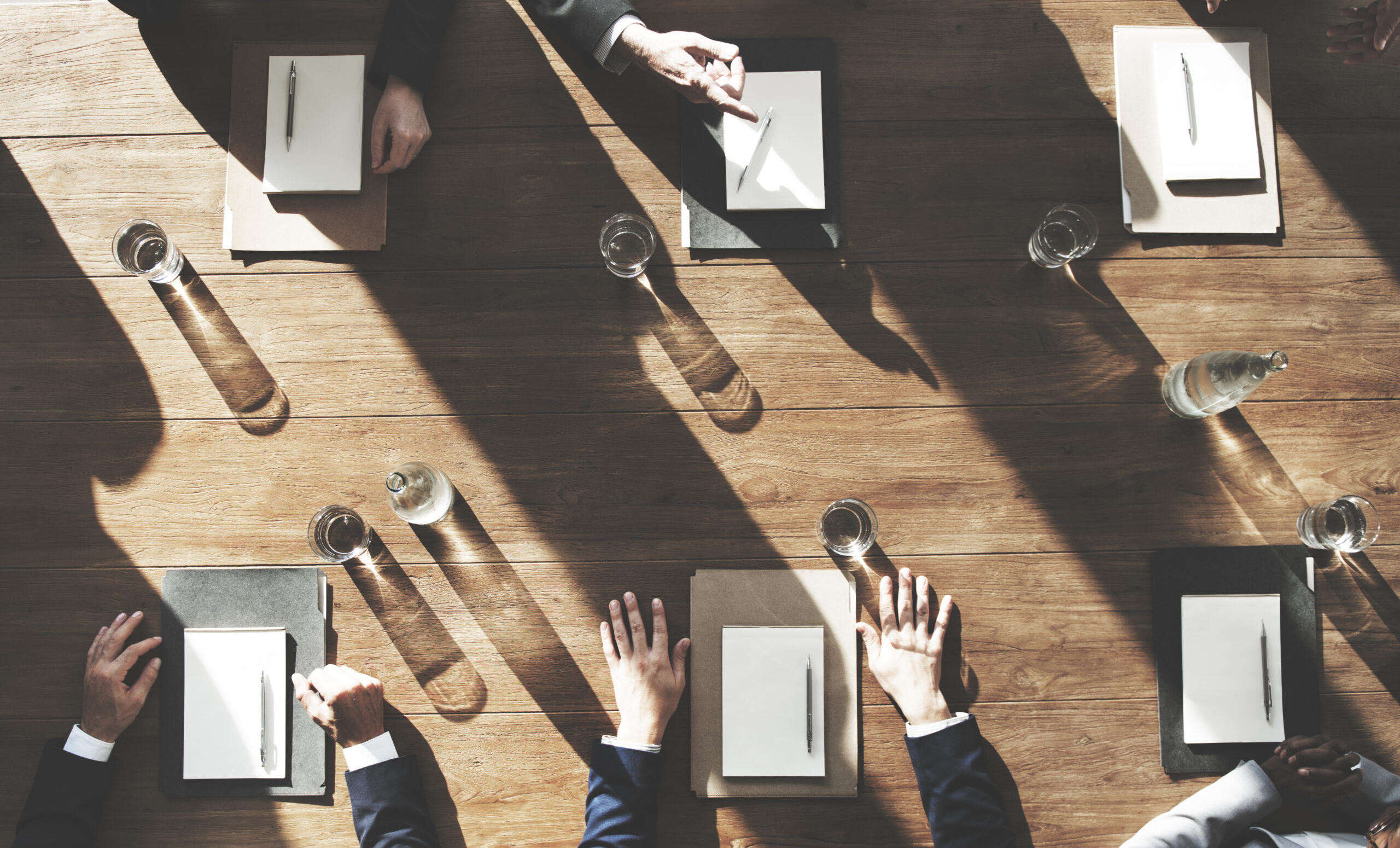 Business meeting with documents and water bottles