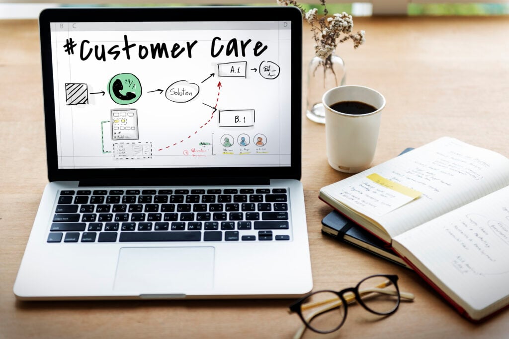 Laptop displaying customer care diagram and notes.