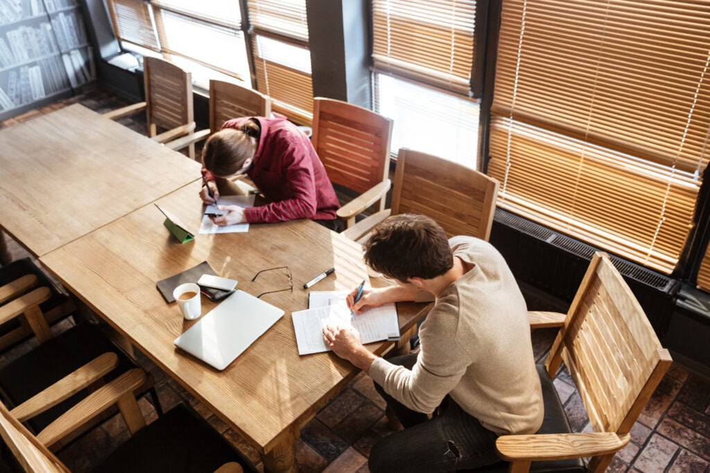 People studying together at a wooden table.