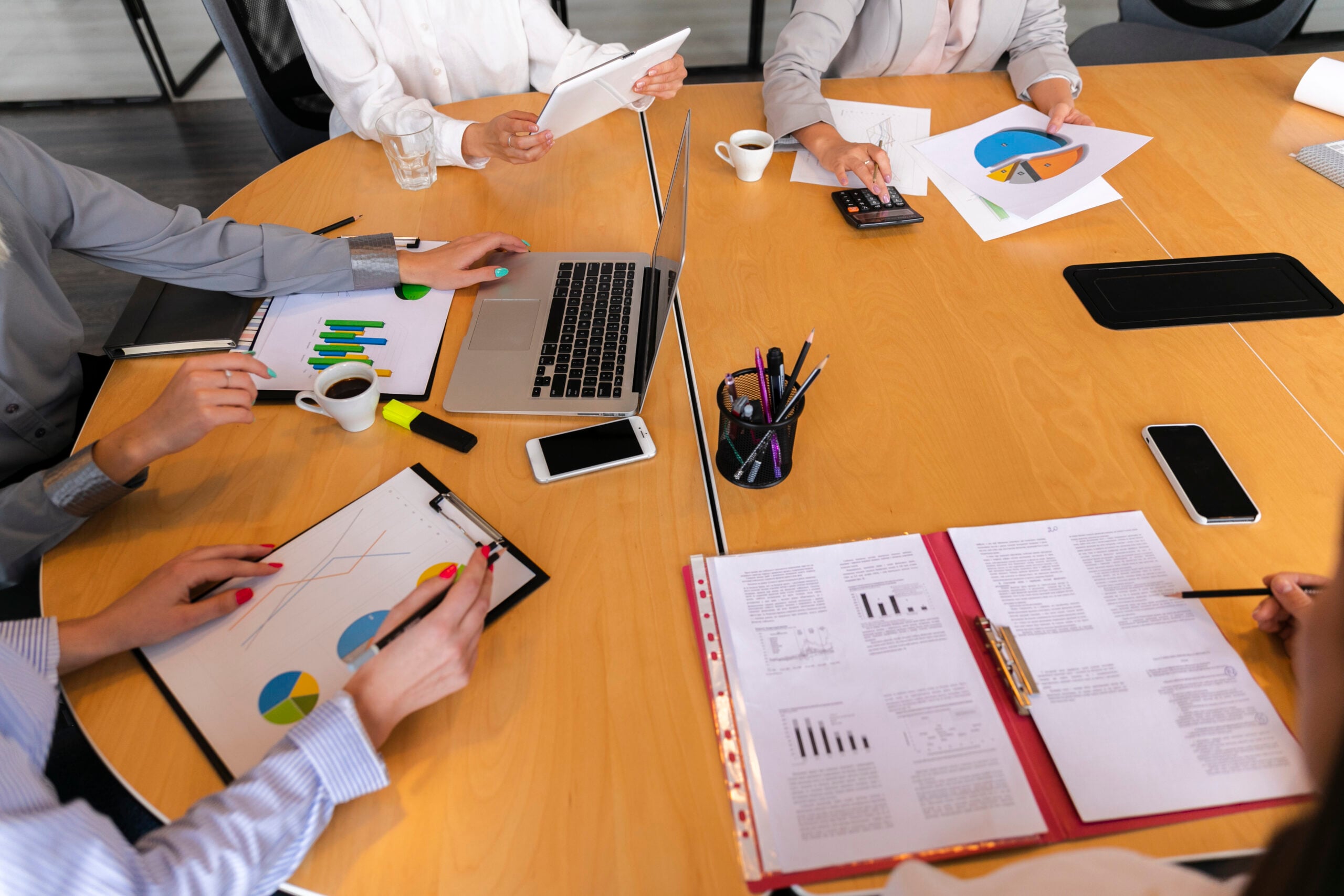 Team meeting discussing financial charts and graphs.