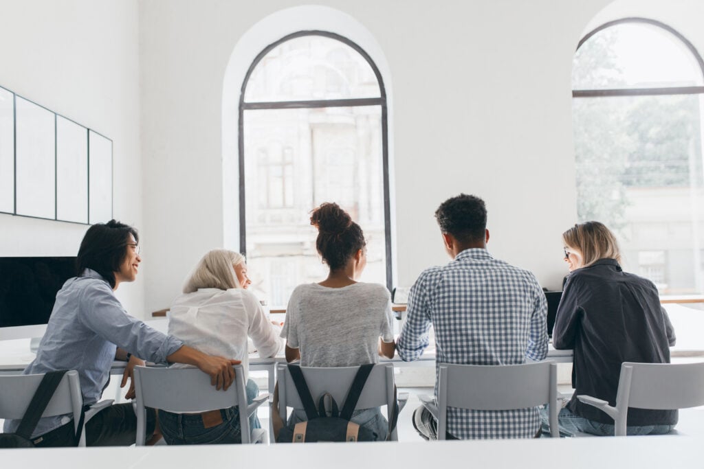 Group of people having a meeting in bright room.