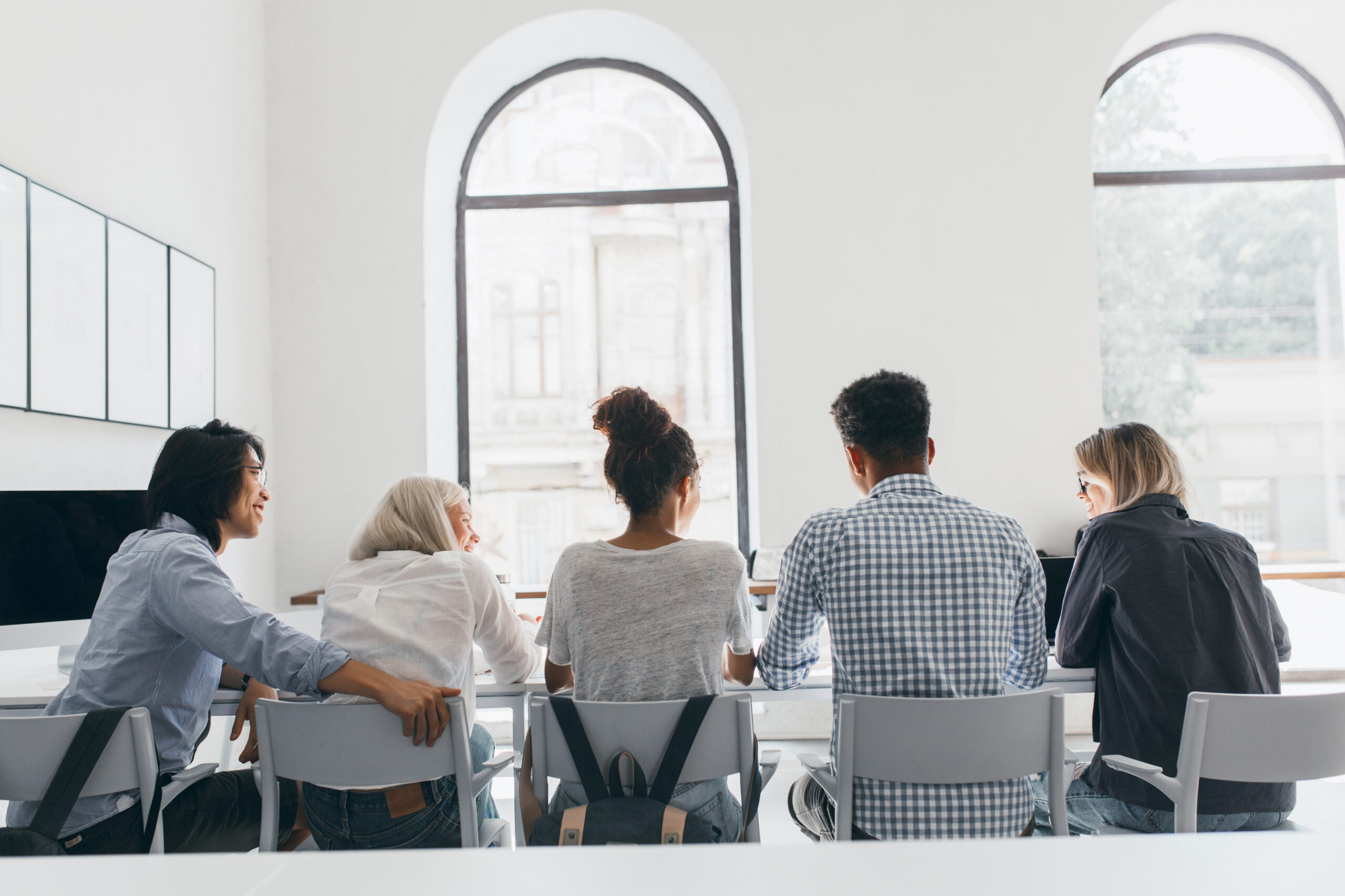 Group of people having a meeting in bright room.